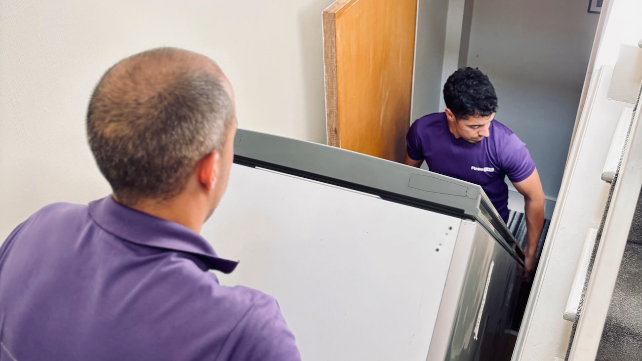 TeamMembersManoeuvringAnAppliance,FinestVan,London