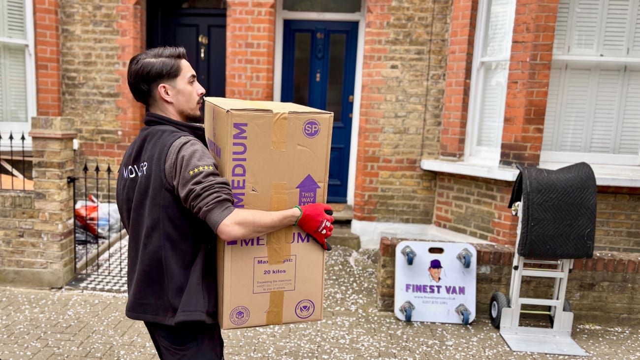 Finest Van mover carrying boxes into a house during a move