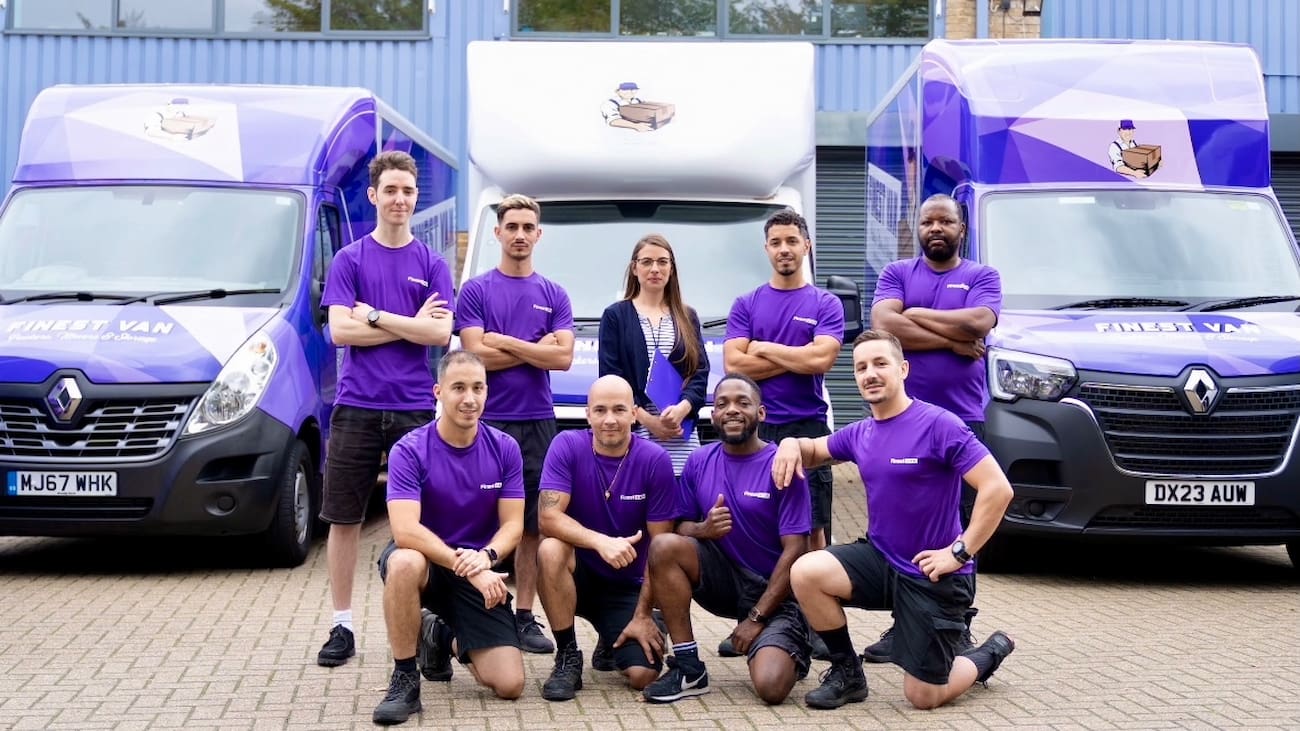 Finest Van removals team standing in front of branded moving vans in London