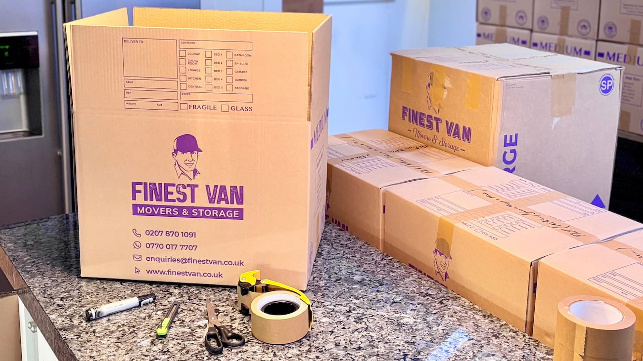 Finest Van branded packing materials and moving boxes prepared on a kitchen worktop for a London house moveFinest Van branded packing materials and moving boxes prepared on a kitchen worktop for a London house move