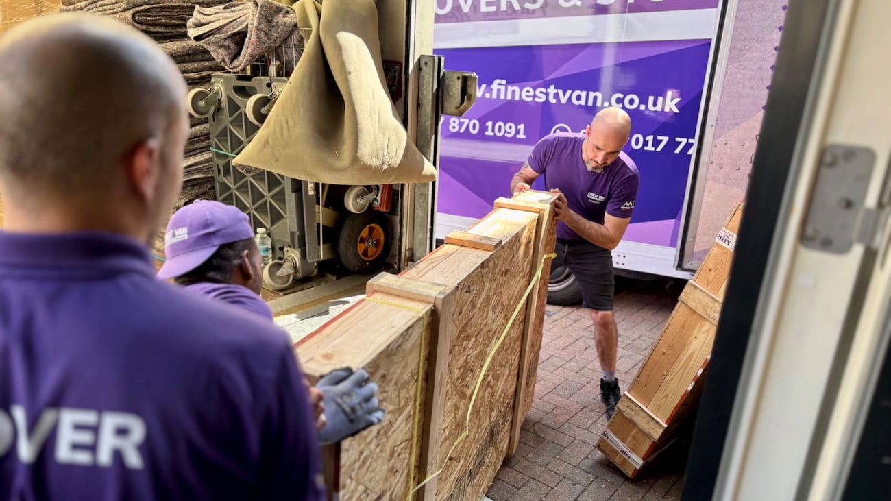 Removal specialists moving a protected artwork crate during a London house move