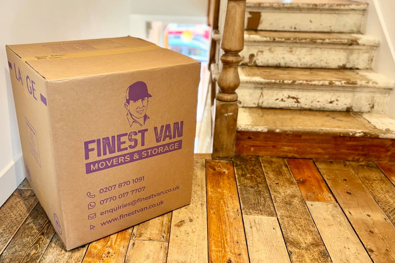 Finest Van packed moving box on an upstairs landing Finest Van packed moving box at the top of the stairs in a family house move